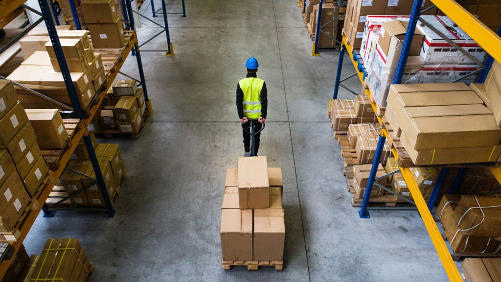 man moving pallet in warehouse